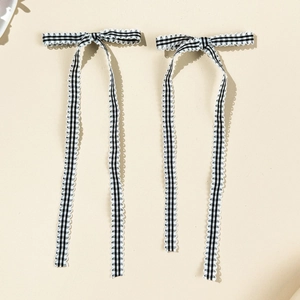Pair of ballet-style black and white plaid bow hair clips with long ribbons and lace edges