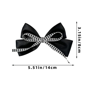 Detail view of a black satin bow hairclip measuring 14cm by 8cm with striped ribbon accent