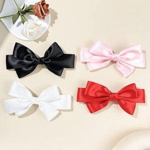 Elegant multi-layered satin bow hair clips in black, pink, white, and red colors