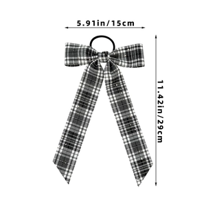 Detail of plaid bow hair scrunchie with sequins and long ribbons showing 29cm length