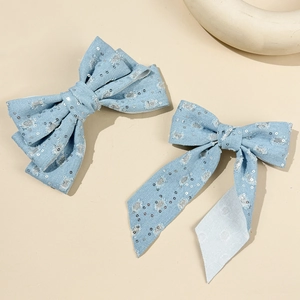 Sparkly denim bow hair clips with silver sequins and distressed details for women