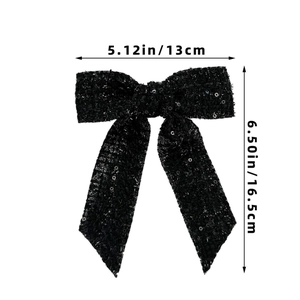 Detail view of a black sequined bow hair clip showing dimensions 13cm by 16.5cm