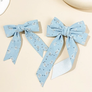 Two-piece light blue denim bow hair clips with silver sequins and vintage style