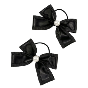 Sweet black satin bow hair ties with pearl centers on a minimalist white background