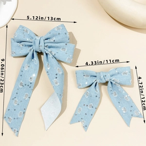 Detail view of denim bow hair clips with sequins and streamers showing dimensions