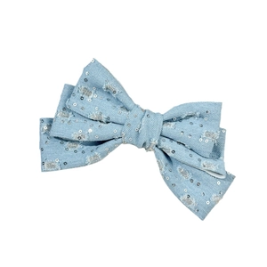 Chic blue denim bow hair clip with silver sequins and distressed Y2K vintage style
