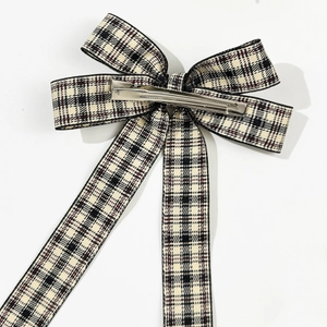 Plaid ribbon bow hair clip with black red white tartan pattern and silver metal grip