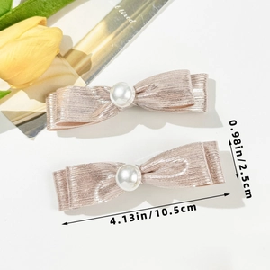 Detailed view of pink glitter bow hair clips with pearls and size measurements