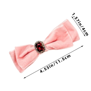 Detailed view of pink velvet bow hair clip with red ruby gem and dimensions 4.53x1.57in
