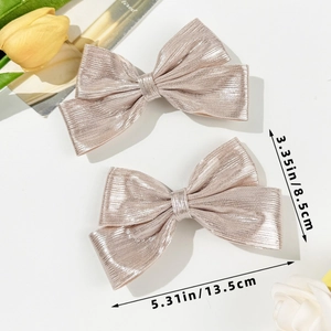 Size specifications for champagne metallic bow hair clips showing 13.5cm width measurements