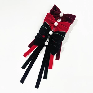 Elegant velvet bow hair clips with large white pearls and long ribbons in multiple colors