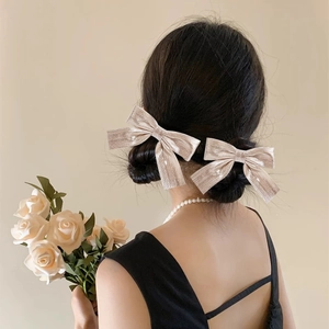 Sparkly champagne gold bow hair clips for women, elegant shimmering fabric hair accessory