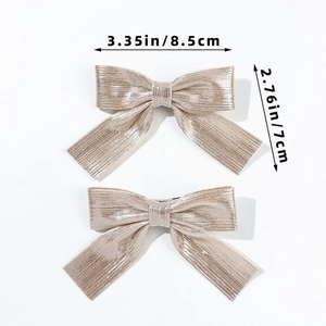Detailed view of champagne glitter bow hair clips with size dimensions 8.5cm by 7cm
