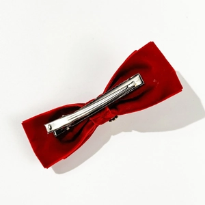Detailed back view of the red velvet bow hair clip showing the silver metal alligator clip
