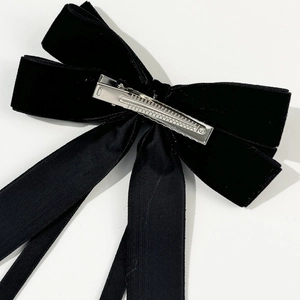 Elegant black velvet bow hair clip with silver alligator clasp on white background