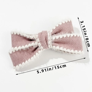 Detailed view of pink knitted bow hair clip with lace trim showing 15cm length size