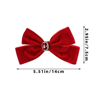 Detail of red velvet bow hair clip with faux ruby center and rhinestone border