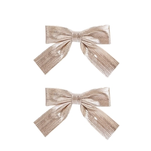 Elegant champagne gold metallic bow hair clips for women with a shiny textured finish