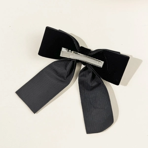 Detail view of the silver alligator clip and black velvet texture on the bow hair clip