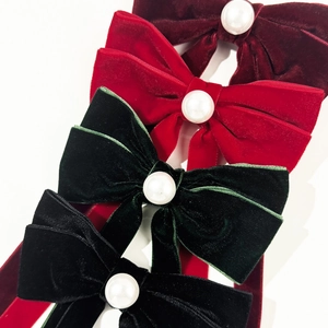 Elegant velvet bow hair clips with white pearls in red, green, and black colors