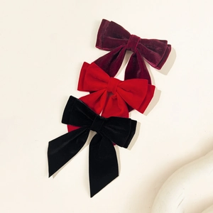 Three elegant velvet bow hair clips in black, burgundy and red, retro style for women