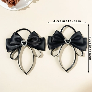 Detail view of 2-pack black satin hair ties with heart rhinestone and dimension labels