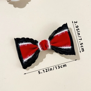 Close-up of red velvet bow hair clip with black lace trim and size dimensions shown