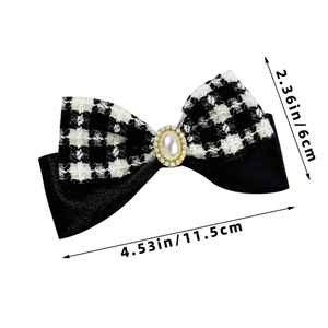 Detail of houndstooth bow hair clip with pearl embellishment and size measurements