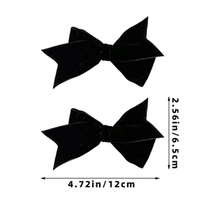 Detailed view of two black velvet bow hair clips with specific size measurements