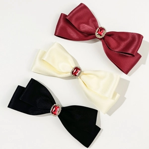 Elegant bow hair clips set with red gemstones in wine red, cream, and black colors