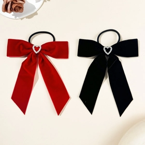 Close-up of velvet bow hair ties with hollow heart rhinestones in red and black