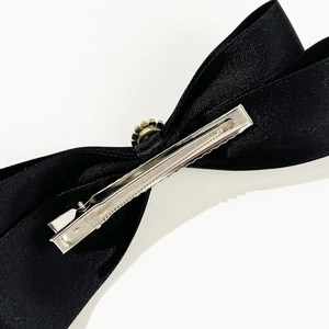 Elegant black satin bow hair clip with a silver metal alligator clasp for women