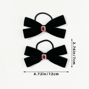 Detail view of two black velvet bow hair ties with red crystals and size measurements
