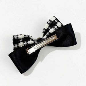 Chic black and white houndstooth bow hair clip with satin ribbon and metal duckbill clip