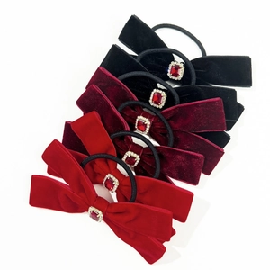 Detail of 6-piece velvet bow scrunchie set with red rhinestones and elastic bands