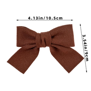 Dettaglio del fermaglio a fiocco marrone scuro con dimensioni di 10,5 cm per 9 cm