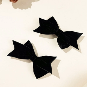 Pair of black velvet bow hair clips for women with elegant vintage ribbon texture