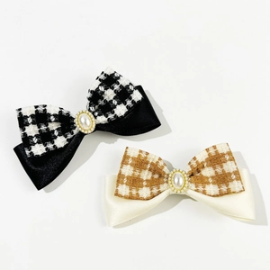 Vintage plaid bow hair clip with pearls and rhinestones on a clean white background