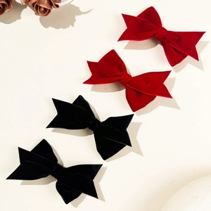 Elegant velvet bow hair clips in red and black colors for women's hair styling