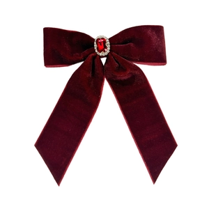 Elegant red velvet bow hair clip with a ruby-style gemstone center and rhinestone border