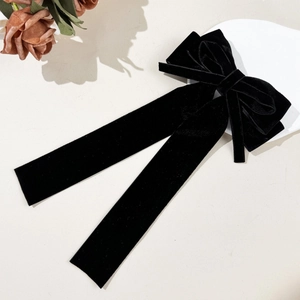 Elegant black velvet hair clip with long streamers and multi-layered bow design