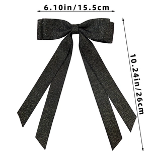 Detailed view of black ribbon bow hair clip with gold glitter threads measuring 15.5x26cm