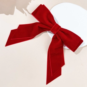 Detailed view of large red double-layer velvet bow hair clip with elegant long ribbons