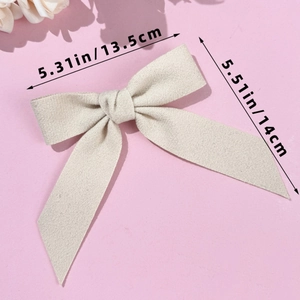 Detail view of oatmeal wool bow hair clip with size dimensions 13.5cm by 14cm