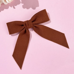 Detailed macro view showing the fine wool texture of this dark brown bow hair clip