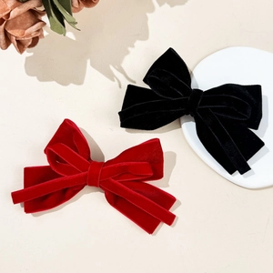 Elegant velvet bow hair clips in red and black colors with a vintage French style
