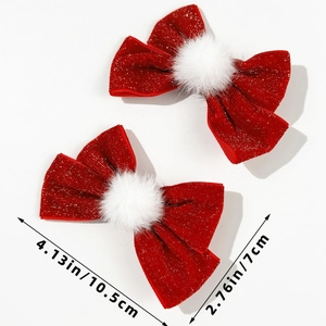 Detailed view showing the 4.13 inch size of red velvet bow hair clips with white pom poms
