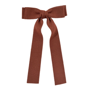 Elegant dark brown wool bow hair clip with long ribbons on a white background