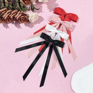 Elegant satin bow hair clips in red, pink, white, and black with long ribbon streamers