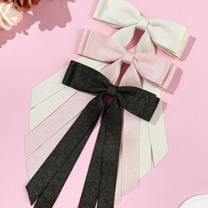 Elegant double-layered bow hair clip with long ribbons in cream, pink, and glitter black
